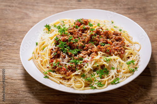 plate of pasta bolognese on a wooden background
