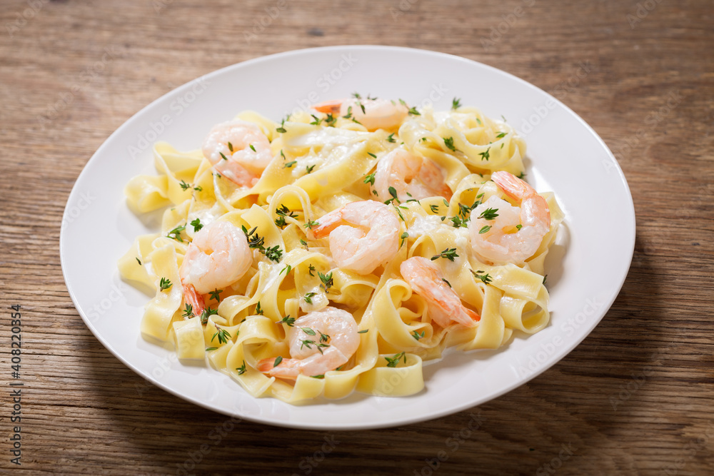 plate of pasta fettuccine with cream sauce and shrimps plate of pasta fettuccine with cream sauce and shrimps