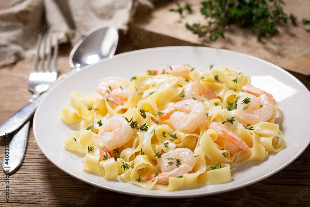 plate of pasta fettuccine with cream sauce and shrimps plate of pasta fettuccine with cream sauce and shrimps