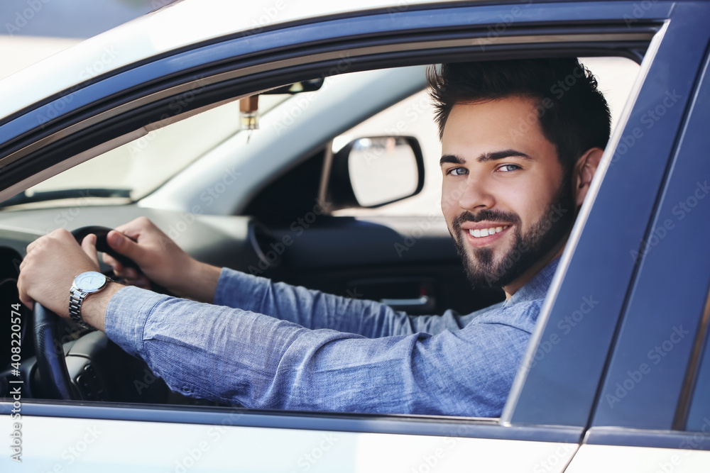 Handsome man with stylish wristwatch driving car Handsome man with stylish wristwatch driving car