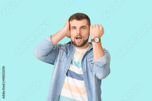 Stressed man with wristwatc...