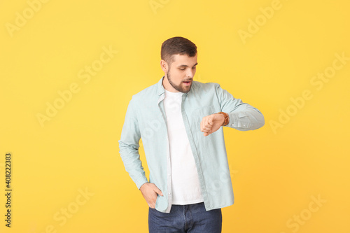 Young man looking at wristw...