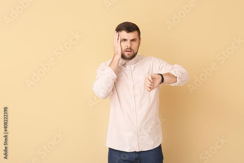 Stressed man with wristwatc...