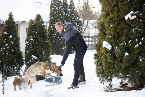 Man Clearing Snow From Path With Shovel