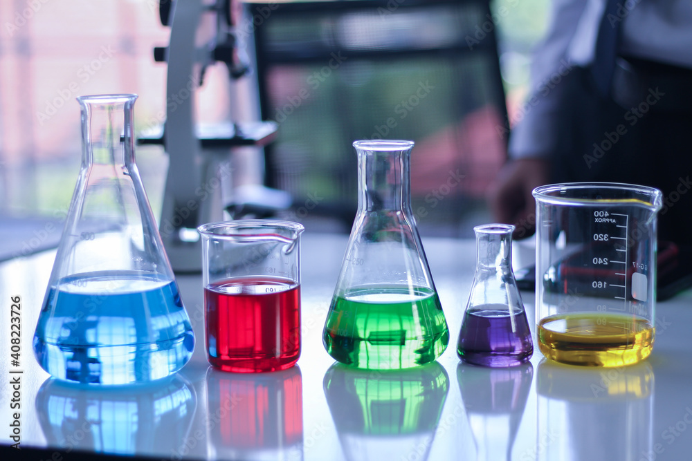 Beaker and glass tubes with colored water inside Beaker and glass tubes with colored water inside