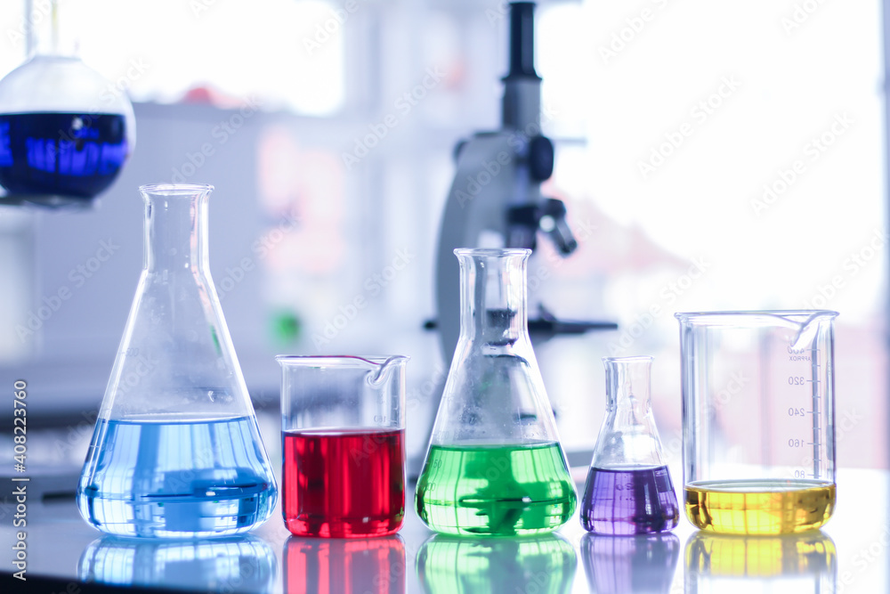 Beaker and glass tubes with colored water inside Beaker and glass tubes with colored water inside