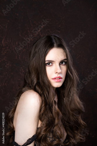 Woman with stylish long hair and no makeup.