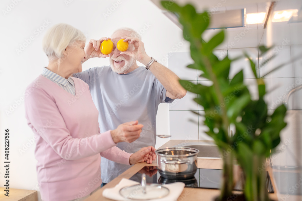 Senior couple cooking together in the kitchen and feeling good Senior couple cooking together in the kitchen and feeling good