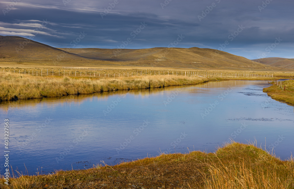 Pampas landscape with river and rolling hills on Tierra del Fuego in autumn