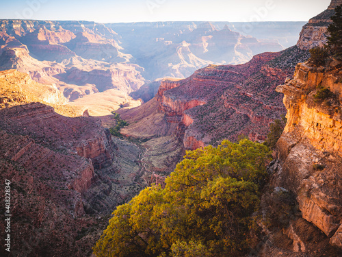Early morning sunlight brightens the Grand Canyon on the Bright Angel Trail. 