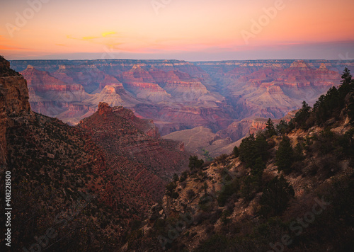 Vivid orange and pink sunset looking over the Grand Canyon at the top of the Bright Angel Trail. 