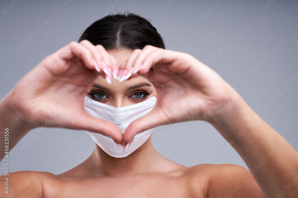 Portrait of beautiful woman in mask on gray background Portrait of beautiful woman in mask on gray background