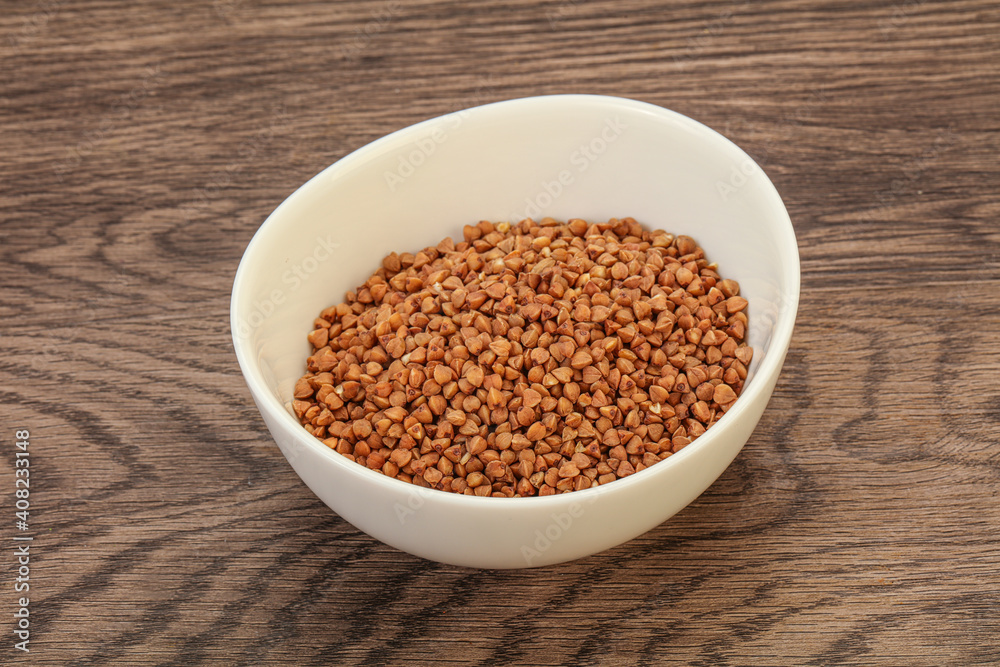 Raw buсkwheat cereal in the bowl Raw buсkwheat cereal in the bowl