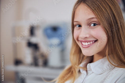 Free Download Pretty young lady in white shirt looking and posing at the photo camera in room indoors - GFXLoad