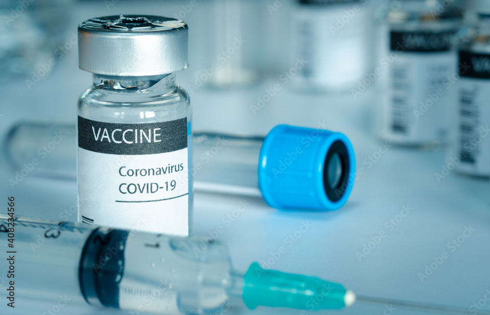 Covid-19 vaccine and syringe injection on a laboratory bench. to fight the coronavirus sars-cov-2 pandemic. Medicine infectious concept. Covid-19 vaccine and syringe injection on a laboratory bench. to fight the coronavirus sars-cov-2 pandemic. Medicine infectious concept.
