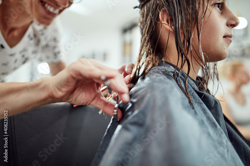 Hairdresser cutting hair in a salon.