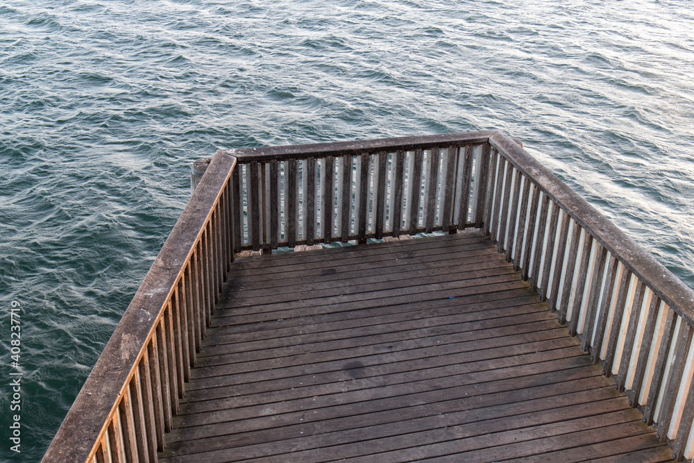 Fototapeta premium Wooden pier on top of water.