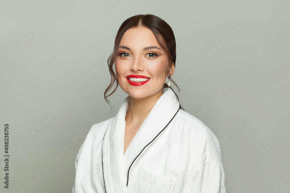 Happy smiling woman in white bathrobe on white background Happy smiling woman in white bathrobe on white background