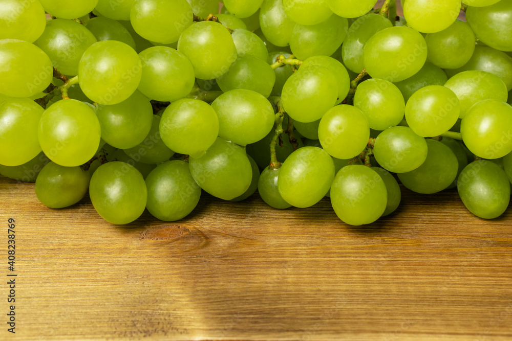 Green grapes on wooden table, close up. Green grapes on wooden table, close up.