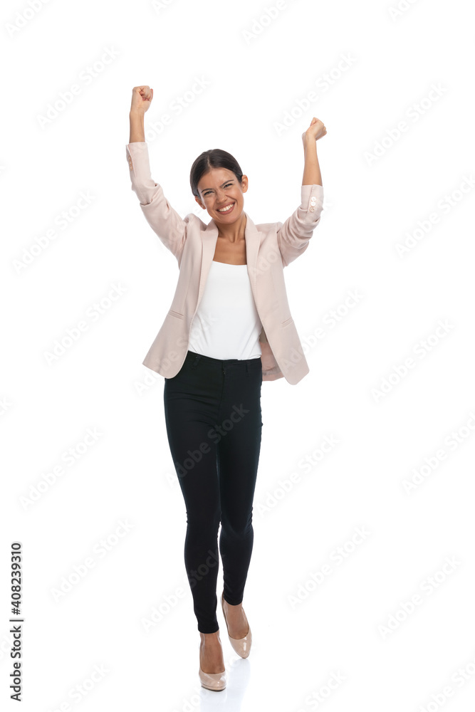 enthusiastic young woman holding arms in the air and cheering enthusiastic young woman holding arms in the air and cheering