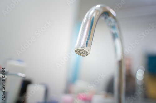 faucet in the bathroom, blurry background