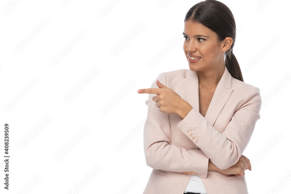 attractive businesswoman in pink jacket pointing fingers to side attractive businesswoman in pink jacket pointing fingers to side