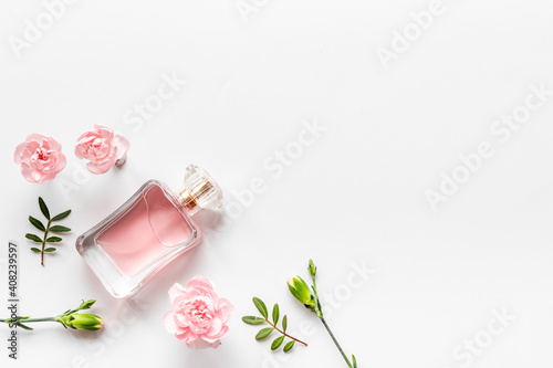 Vászonkép Transparent perfume with flowers and leaves