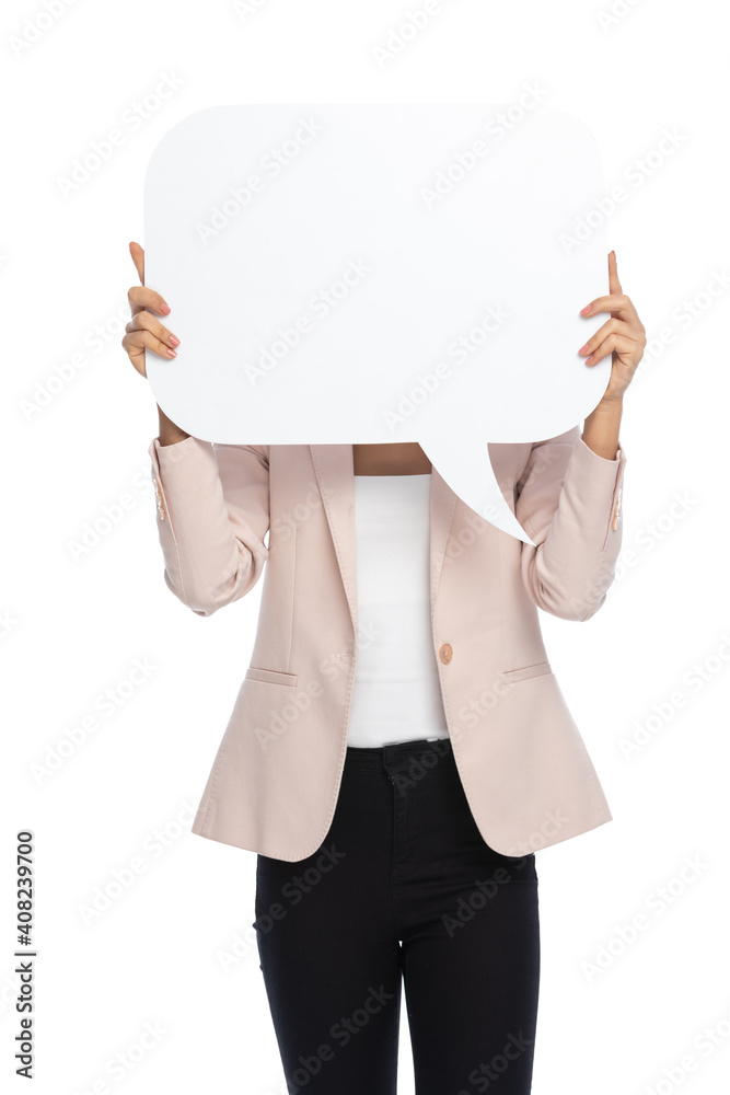timid young businesswoman hiding behind empty speech bubble timid young businesswoman hiding behind empty speech bubble