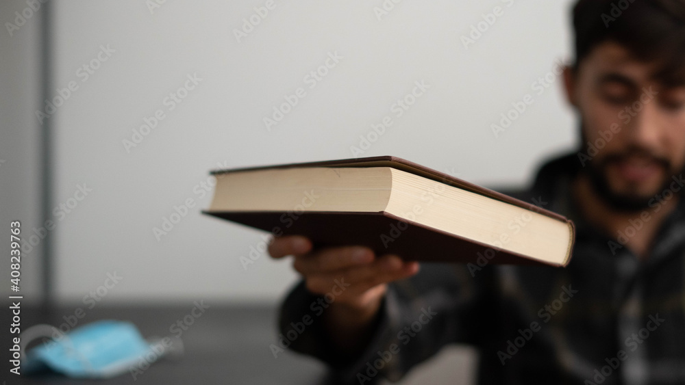 Naklejka premium Young man with a book in his hand