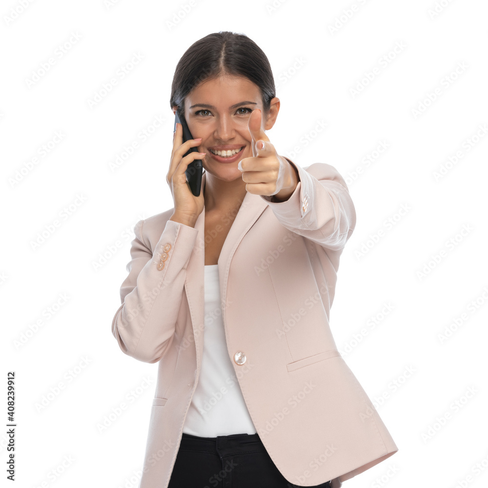 sexy young woman talking on the phone and pointing fingers sexy young woman talking on the phone and pointing fingers