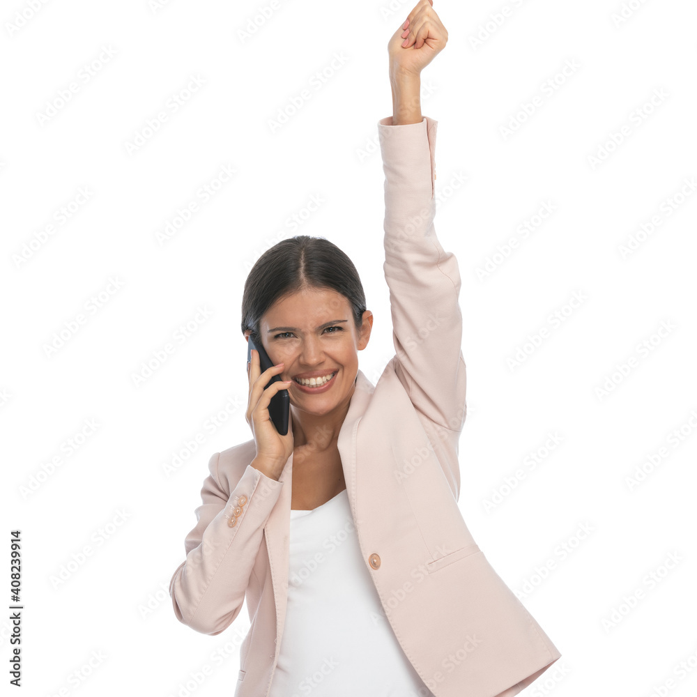 happy businesswoman talking on the phone and holding arm up happy businesswoman talking on the phone and holding arm up