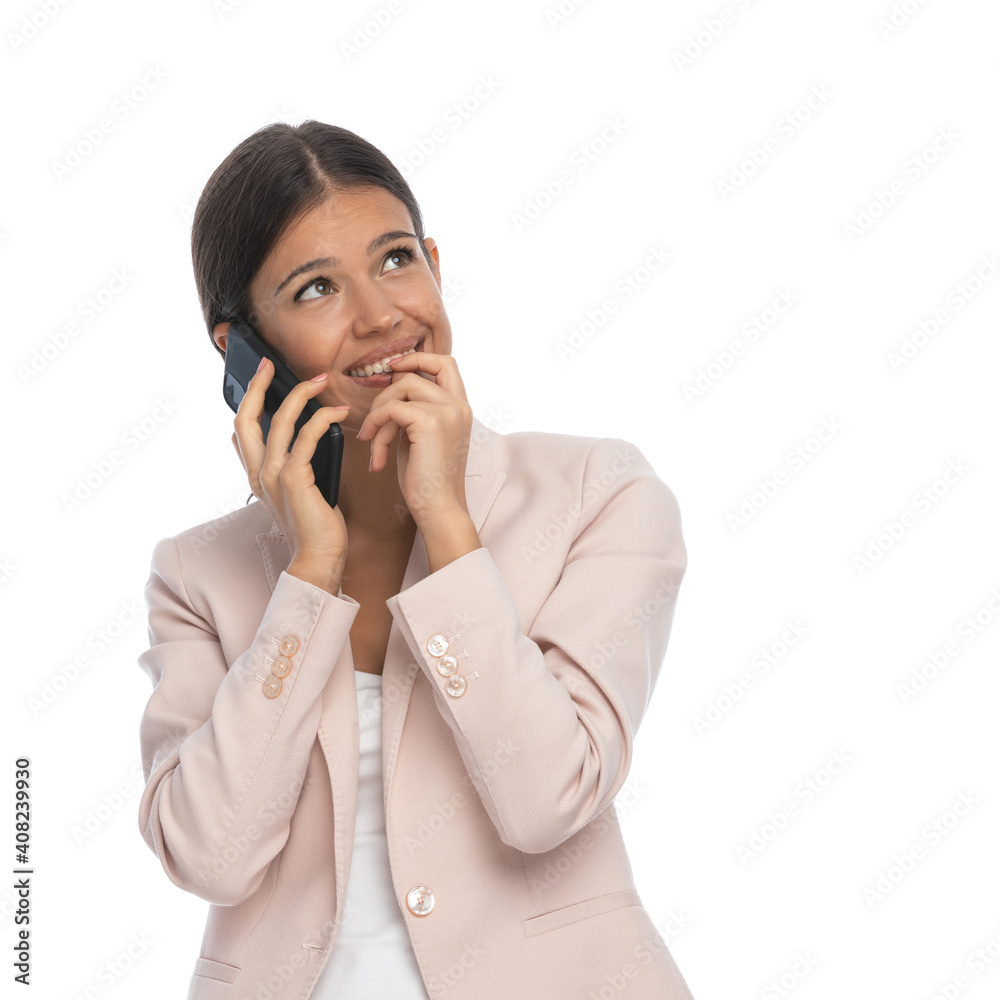 beautiful young girl talking on the phone and looking up dreaming beautiful young girl talking on the phone and looking up dreaming