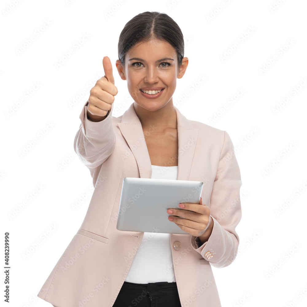portrait of smart casual businesswoman in pink jacket making thumbs up gesture portrait of smart casual businesswoman in pink jacket making thumbs up gesture
