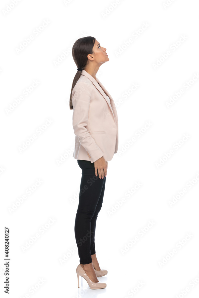 side view of smart casual businesswoman looking up and waiting in line side view of smart casual businesswoman looking up and waiting in line
