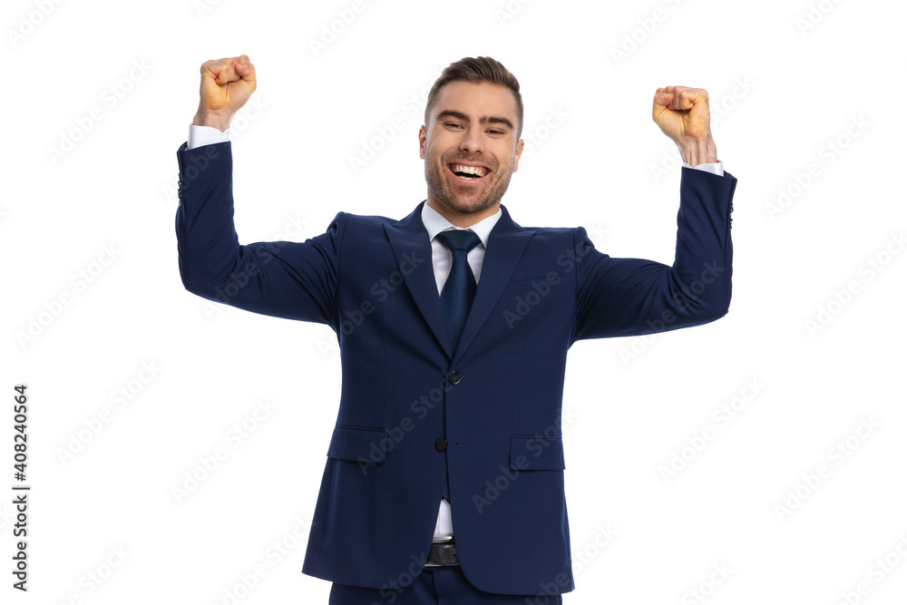 excited young businessman holding fists in the air and celebrating excited young businessman holding fists in the air and celebrating