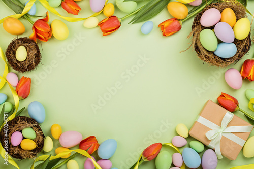 Stylish background with colorful easter eggs pastel colors isolated on green background. Flat lay, top view, mockup, overhead, template