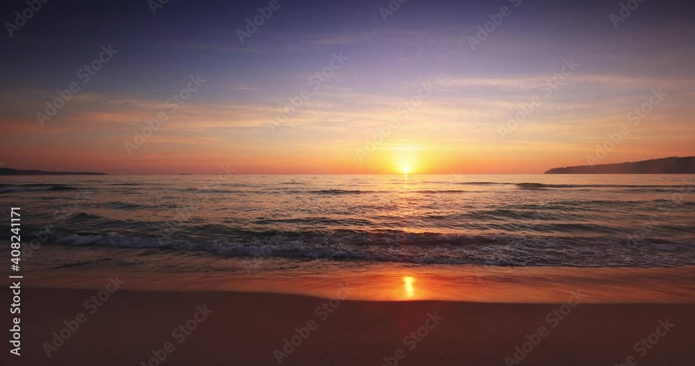 Sea sunrise with colorful cloudscape on sandy beach