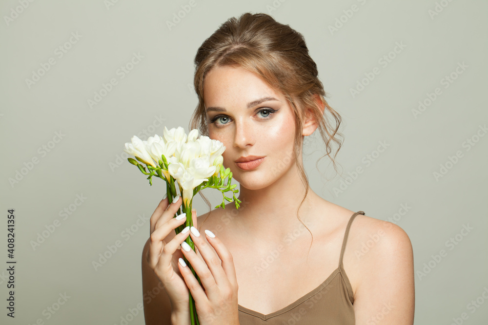 Stylish young woman with white flowers on white background Stylish young woman with white flowers on white background