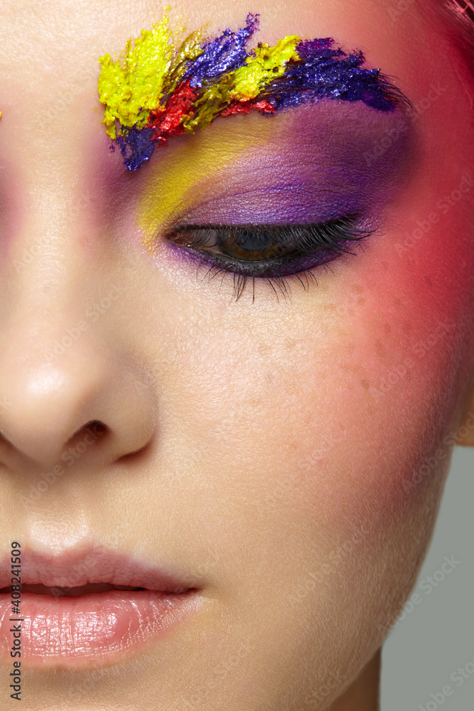 Fototapeta premium Close-up female half face portrait with unusual face art make-up and freckles.