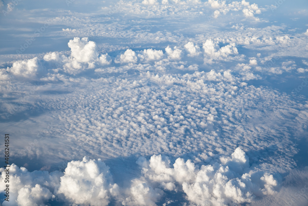 Fototapeta premium Aerial view of Blue sky and Cloud Top view from airplane window,Nature background. Sky and clouds.