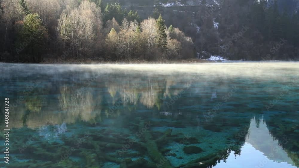 The morning mist floating over the lake. The beautiful Jiuzhaigou Valley, National Park in winter in aba prefecture, sichuan province, China. Inclusion on the World Natural Heritage List in 1992. The morning mist floating over the lake. The beautiful Jiuzhaigou Valley, National Park in winter in aba prefecture, sichuan province, China. Inclusion on the World Natural Heritage List in 1992.