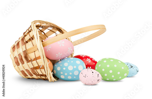 Canvas Print basket with scattered easter eggs on isolated white background