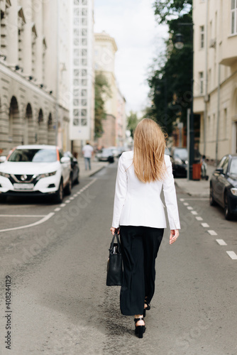 A woman with a bag on the background of the city