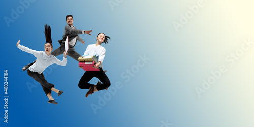 Morning. Happy office workers jumping and dancing in casual clothes or suit isolated on gradient neon fluid background. Business, start-up, working open-space, motion, action concept. Creative collage
