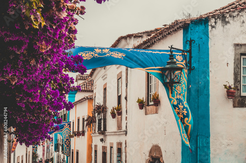 OBIDOS, PORTUGAL - 08-09-2020 : Souvenir shops and colorful narrow streets of the medieval portuguese city of Óbidos, a tourist attraction in central Portugal. famous destination for its architecture
