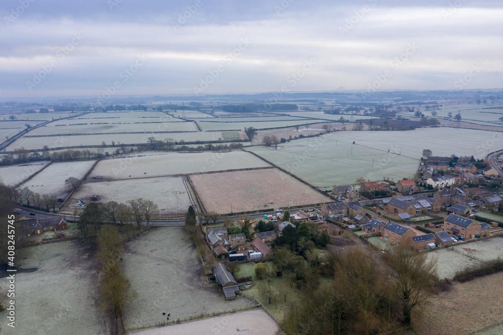 Aerial photo of the British country side taken on a cold winters frosty morning showing an aerial view of the cold British scenic rural area in the UK village of Wetherby in West Yorkshire