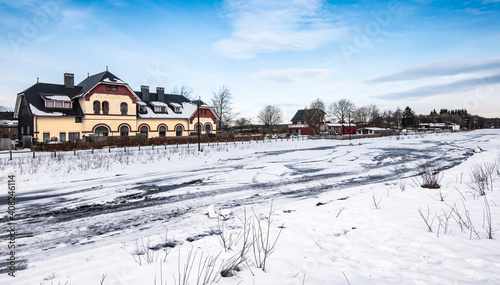 Snowy landscape with old train station in Sourbrodt, Waimes, Ardennes, Belgium.
