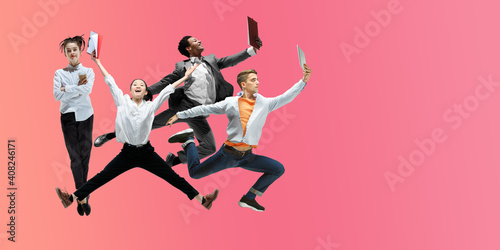 Raspberry. Happy office workers jumping and dancing in casual clothes or suit isolated on gradient neon fluid background. Business  start-up  working open-space  motion  action concept. Creative