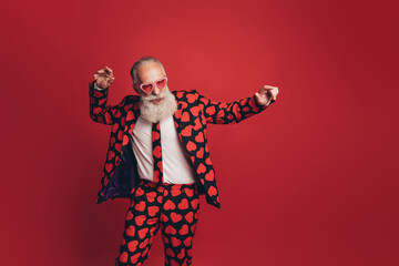 Photo of carefree funky old man vintage retro disco dance wear heart print suit isolated red background