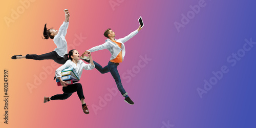 Purple. Happy office workers jumping and dancing in casual clothes or suit isolated on gradient neon fluid background. Business, start-up, working open-space, motion, action concept. Creative collage.